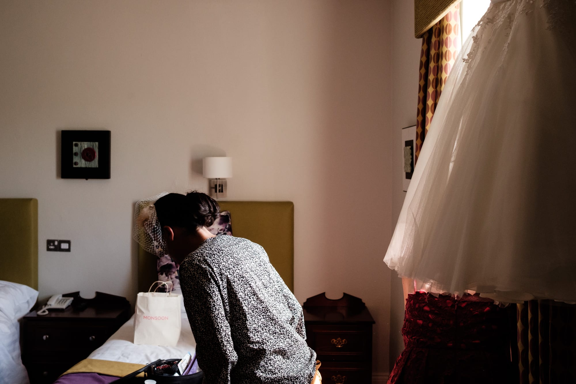 Bride preparing with dress hanging